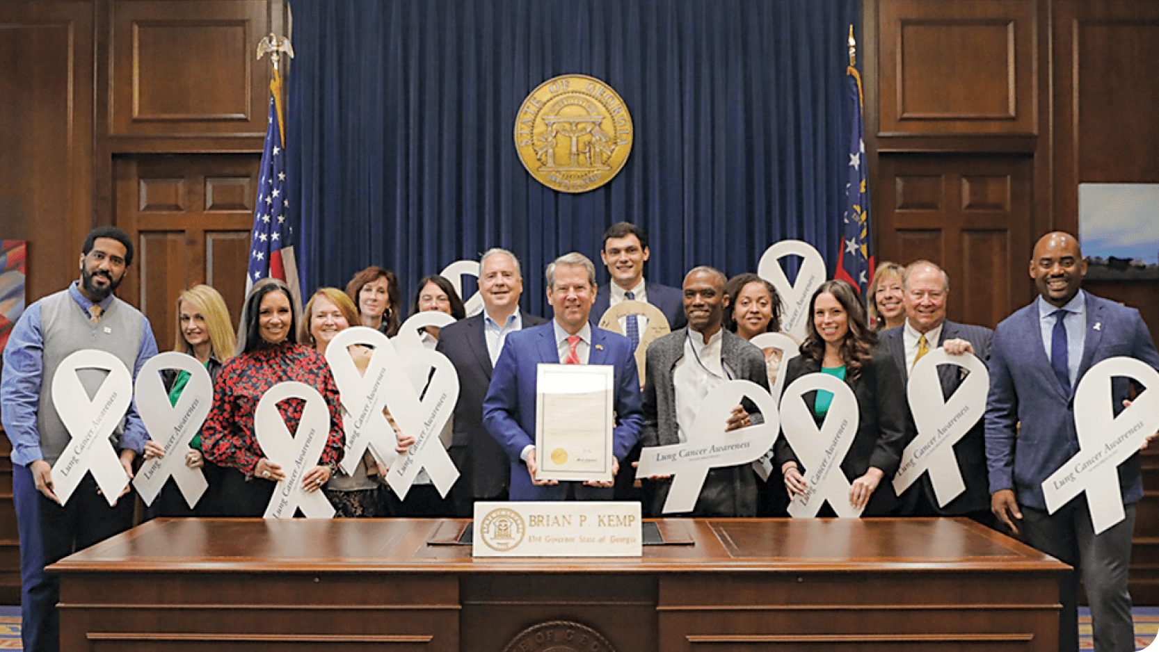 Georgia CORE staff and Governor Brian Kemp holding lung cancer awareness ribbons at the Georgia State Capitol